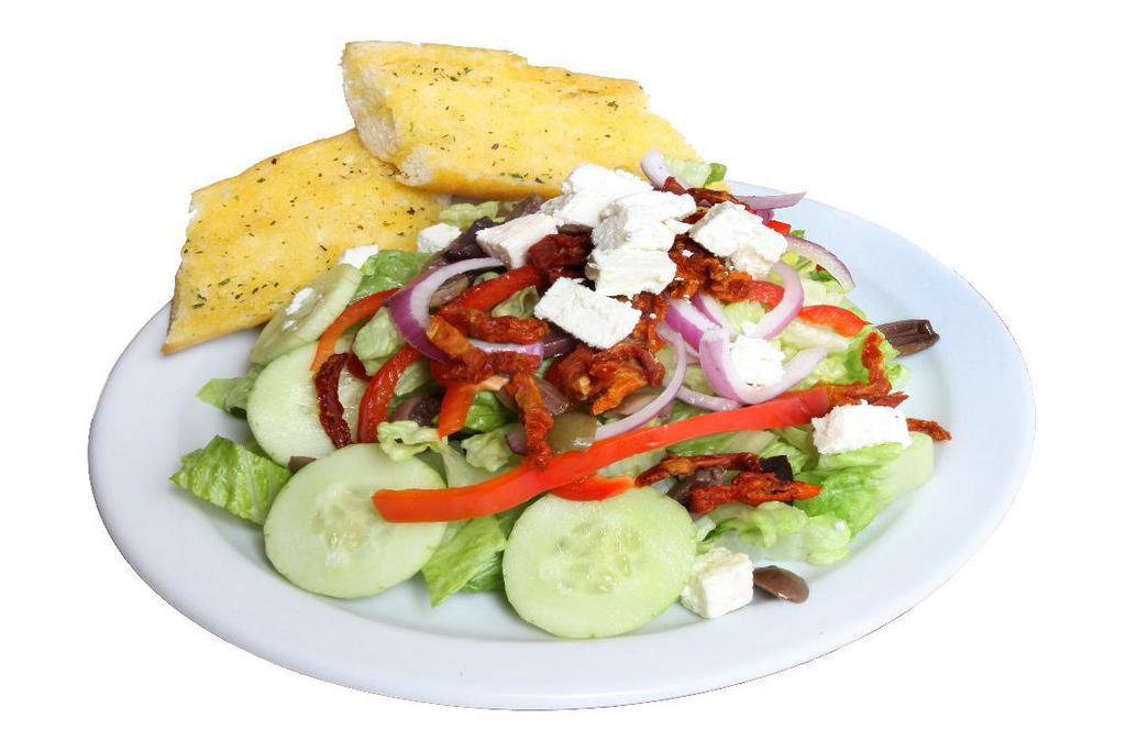 Green Salad · Iceberg lettuce, red onions, green bell peppers, black olives, tomatoes, garbanzo beans, pepper chines and choice of dressing. Served with garlic bread.