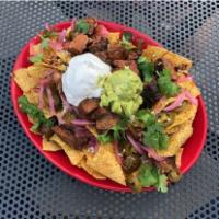 Smoked Brisket Nachos · Prepared with smoke. Chips with cheese and a variety of toppings.