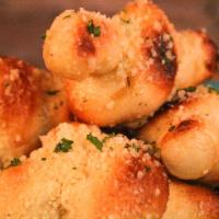 Vegan Garlic Knots  · Hand knotted dough baked fresh to order. Topped with a buttery blend of spices, garlic and v...