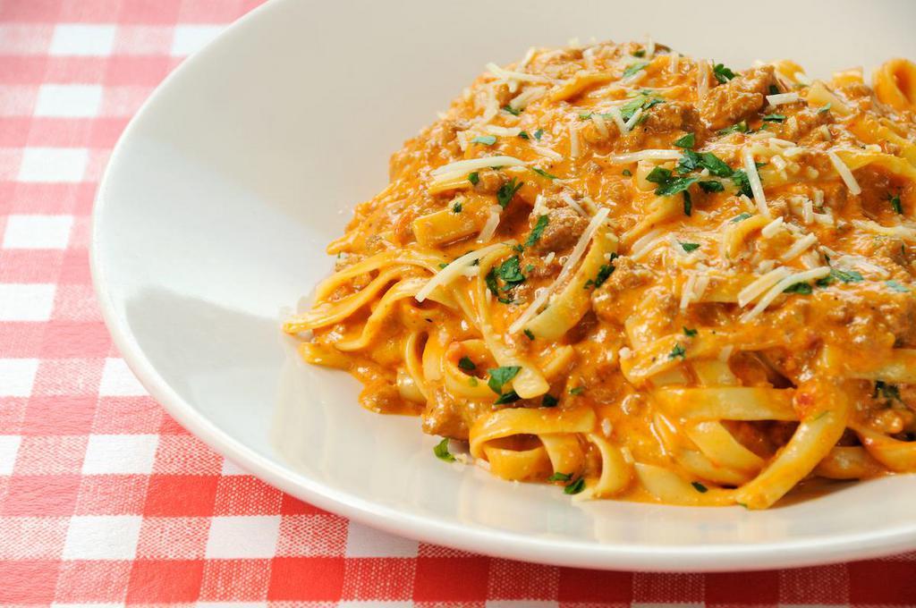 Fettuccine Bolognese · Meat ragu with creamy rose.