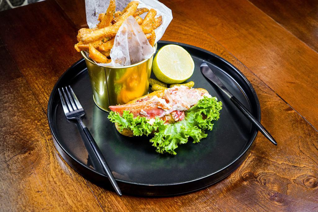 LOBSTER ROLL · Baked live lobster with lemon aioli served with truffle frites.