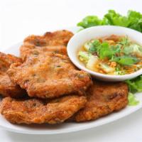 A8. Fried Fish Cake · 4 pieces. Ground fish and green bean patties, seasoned with curry paste. Served with cucumbe...