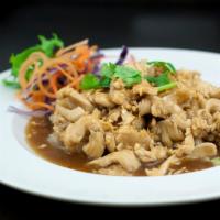 EN3. Pad Gra Tiam Prik Thai · Stir-fried in a garlic and black pepper sauce, topped with cilantro, fried garlic, and lettu...
