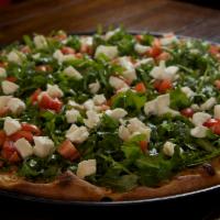 Arugulacious Pizza · Baby arugula accompanied by plum tomatoes and fresh mozzarella. Topped with olive oil, salt,...