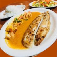 Sea and Sea · Sea bass filet grilled sided by 4 shrimps in garlic sauce. 2 sides.