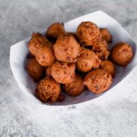 Basket of Hush Puppies · Crispy on the outside, soft on the inside, and hand-dipped fresh, right when you get here (p...