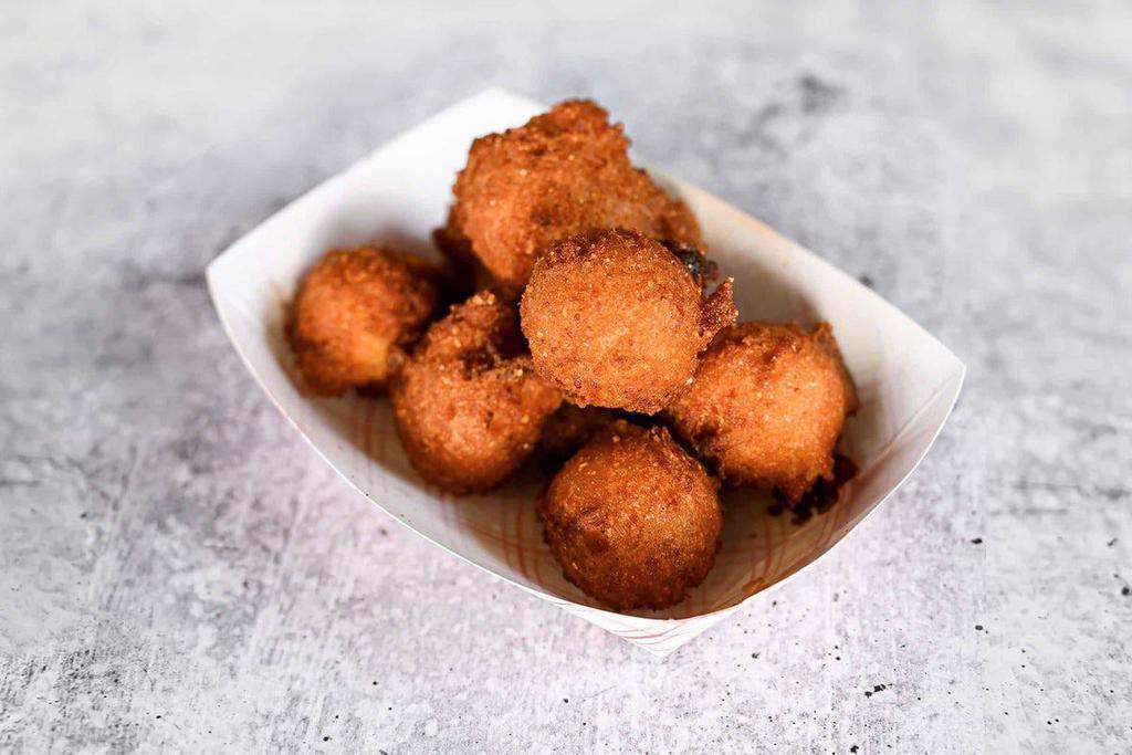 Hush Puppies · Crispy on the outside, soft on the inside, and hand-dipped fresh, right when you get here (please allow three minutes)