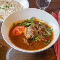 Goat Curry · Indian curry sauce. Goat with bones cooked in yogurt, herbs and spices. Served with rice.