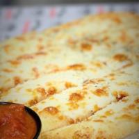 Cheesy Bread Stix · Breadsticks topped with gartic butter and mozzarella cheese and served with a side of marina...