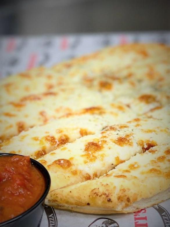 Cheesy Bread Stix · Breadsticks topped with gartic butter and mozzarella cheese and served with a side of marinara.