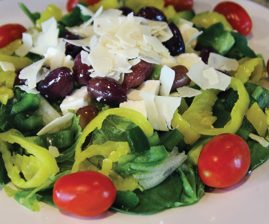 Greek Salad · Romaine and iceberg lettuce, spinach leaves, feta cheese, green peppers, Greek olives, banana peppers, grape tomatoes and shaved Asiago cheese.