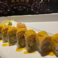 American Dream Roll · Rock shrimp tempura inside, topped with spicy lobster and kani and spicy mango sauce.