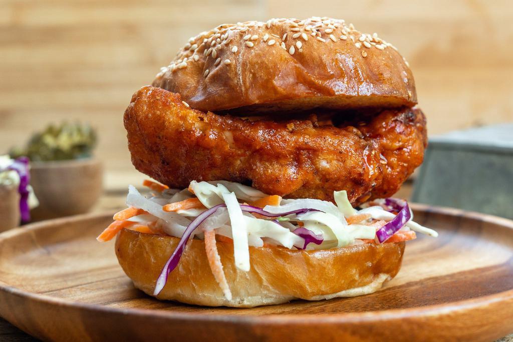 KFC Sandwich · Korean fried chicken breast tossed in a sweet and spicy Korean Chile sauce served with pickled daikon and pickled carrot tossed together with slaw.