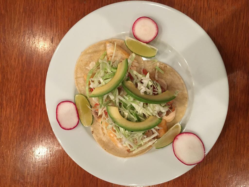 Fish Tacos · Three soft corn tortillas topped with cabbage, pico de gallo, avocado and creamy chipotle sauce.