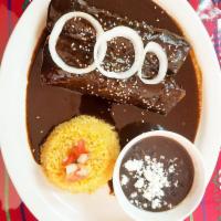 Cheese mole negro enchiladas · two cheese enchiladas topped with homemade mole, onions,sesame seeds,rice and black beans on...