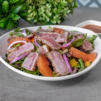 Seared Ahi Tuna Salad · Spring mix, bell peppers, red onions, orange segments, and blood orange vinaigrette.