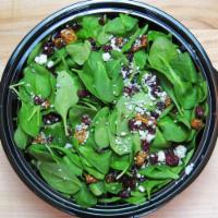 Spinach Salad · Baby spinach, candied walnuts, dried cranberries and Gorgonzola, served with honey-balsamic ...