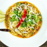 53. Kai Soy Noodles · Steamed egg noodle and pickle green mustard topped with chicken, yellow curry, red onions, s...