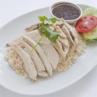117. Gai Tom  · Served with delicious ginger soy bean chili sauce and broth soup steamed tender chicken on g...