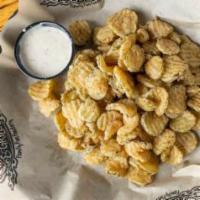 Fried Pickles · Sliced crinkle cut pickle chips, lightly breaded and fried golden-brown. Served with Cajun r...