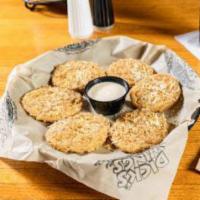 Fried Green Tomatoes · Fresh green tomatoes. Breaded and deep-fried, topped with Parmesan cheese and garlic pepper ...
