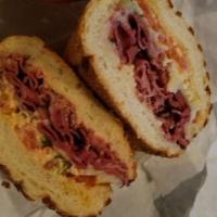Hot Pastrami Sandwich · Pastrami brisket marinated overnight steamed in our kettle, cheddar cheese, Lou's special sa...