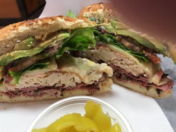 Risky Bizness Sandwich · Hot pastrami brisket, crab salad, bacon, avocado, pepper jack cheese, pepperoncinis, Lou's special sauce and on a dutch crunch roll. Include: lettuce, tomatoes, red onions, pickles and jalapeno spread.