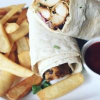 Lebanese Chicken Shawarma · Tender chicken marinated in Lebanese spices over saffron rice, topped with tahini sesame sau...