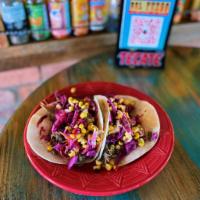 Pulled Pork Tacos  · Roasted corn salsa, red cabbage slaw, and mango BBQ sauce.