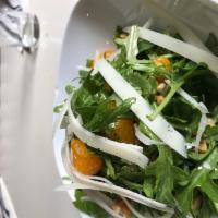 Roka Salad · Baby arugula, walnuts, kefalograveria cheese, orange segments, lemon basil dressing.
