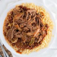 Ropa Vieja / Shredded Beef (D) · Shredded beef with peppers and onions in a savory red sauce. Served with rice and beans.
