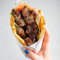 Pork Souvlaki on Pita · All natural, marinated and cooked to perfection on char-broiler or rotisserie. Served with t...