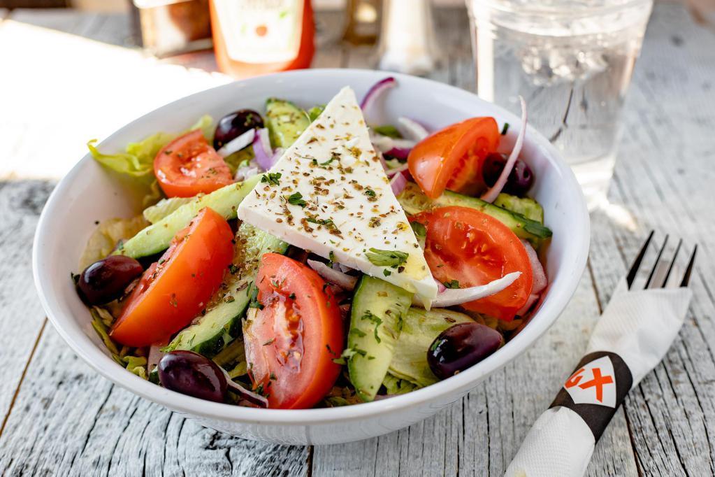 Greek Salad · Lettuce, ripe tomatoes, red onion, cucumber, Kalamata olives, feta cheese topped with our homemade vinaigrette dressing. Served with a regular toasted pita.