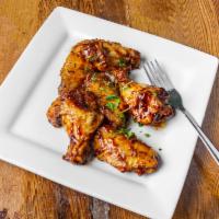 Honest Chicken Wings · Wings and drummettes tossed in house made organic BBQ sauce then baked to tenderness. (No fr...