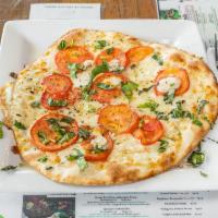 Classic Margherita Pizza · Fresh Roma tomatoes, fresh mozzarella, and fresh basil on choice of base.