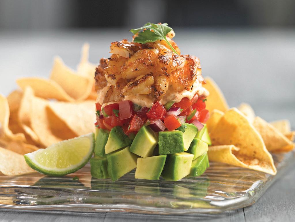 Fresh Avocado and Shrimp Stack · Fresh avocado, pico de gallo and spicy chipotle ranch dressing layered and topped with Cajun-grilled shrimp. Served chilled with crispy tortilla chips.