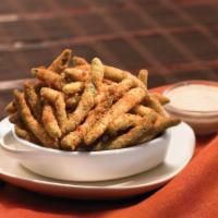 Crispy Green Beans · Onion-battered green beans fried to a crisp, golden brown and seasoned with Cajun spices. Se...