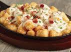 Loaded Tots · Crispy tots topped with poblano cheese sauce, applewood smoked bacon and chopped parsley.