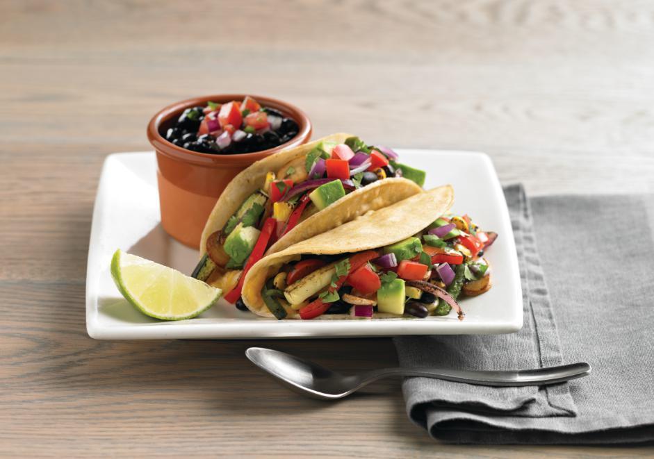 Veggie Tacos · Grilled red onions, mushrooms, poblano peppers, red bell peppers, zucchini and our three-cheese blend inside soft corn tortillas. Topped with roasted corn, black beans, avocado and pico de gallo. Served with black beans. No additional side included.