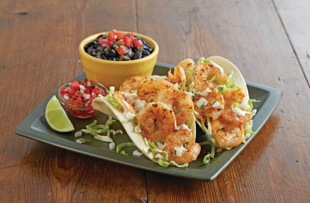 Grilled Shrimp Street Tacos · Grilled ancho-marinated shrimp, shredded cabbage, onion, cilantro and chipotle ranch dressing inside soft corn tortillas. Served with black beans and fresh pico de gallo. No additional side included.