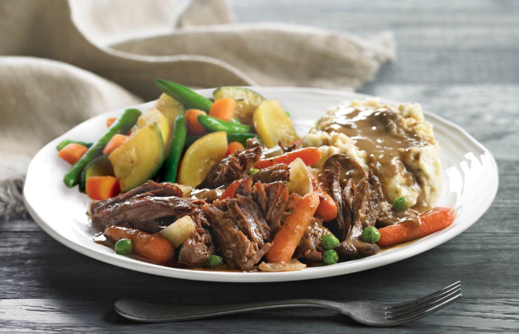 Braised and Slow-Roasted Pot Roast · Tender chunks of chuck roast slow-simmered for full flavor and tenderness, topped with mushroom cabernet gravy. Served with fresh mashed potatoes and fresh seasonal vegetables.