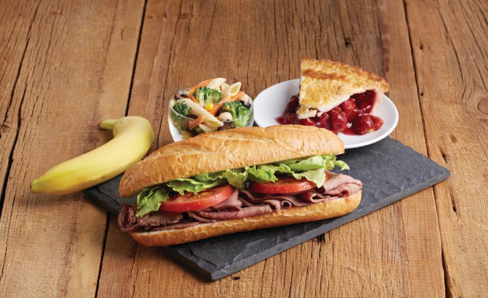Roast Beef on a Baguette Boxed Lunch · Thinly sliced roast beef with lettuce and tomato.