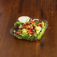 California Cobb Salad · Avocado, bacon, tomatoes, red onion and cucumbers on a bed of spinach and green leaf, with o...