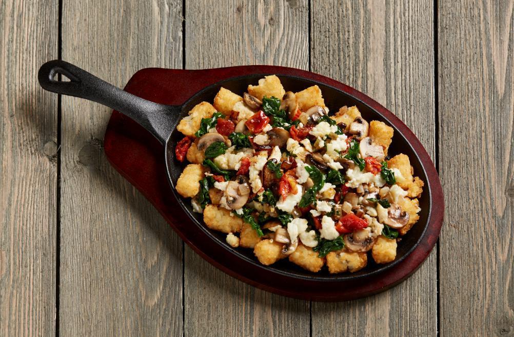 Spinach and Mushroom Skillet · Fresh from the garden. Spinach, onions, mushrooms, oven-roasted tomatoes and egg whites over crispy tots. Vegetarian.