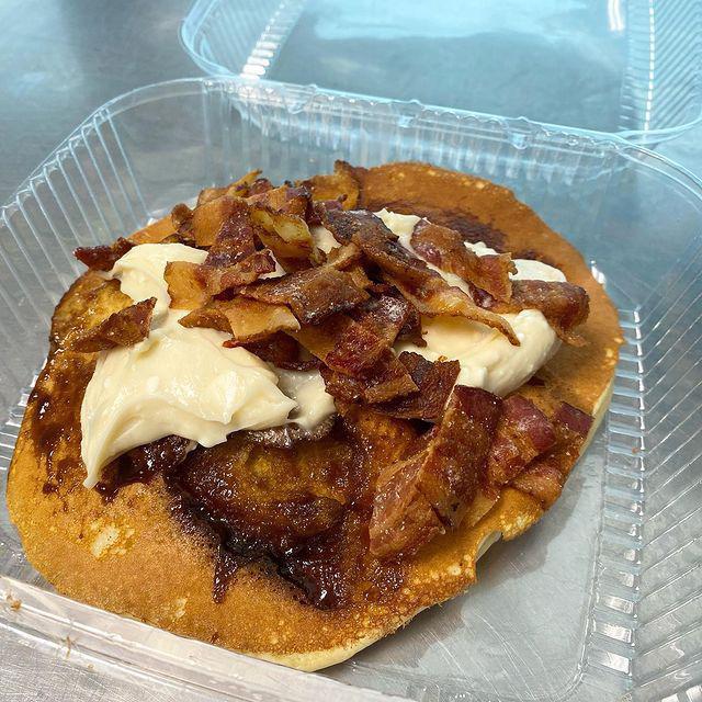Cinnamon Bun Pancakes · Cinnamon & Brown Sugar Swirled into 3 of our Pancakes, topped with Cream Cheese Glaze & Candied Bacon