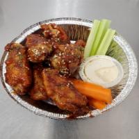 Crispy Chicken Wings · Crispy chicken wings coated with house sauce.