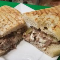 Philly Cheese Steak Panini · Steak, Provolone Cheese, Sautéed Peppers & Onions.