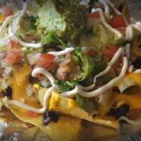 Nachos · Melted cheese, beans, sour cream, lettuce, pico de gallo and choice of meat.