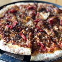 The Carnivore Pizza · Marinara sauce. Italian sausage, ground beef, pepperoni, Canadian bacon and mozzarella.