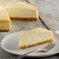 Traditional New York Cheesecake · A creamy, rich New York cheesecake sits on a graham cracker base.
